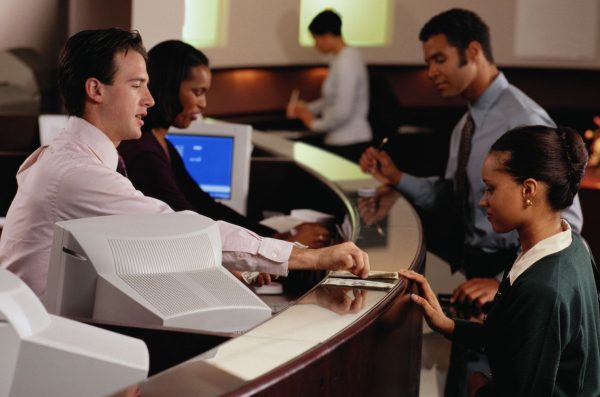 Bank teller exchange with customer