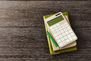 calculator, notebook and pencil