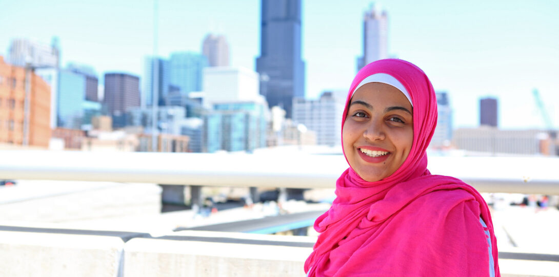 smiling student wearing hijab with Chicago in background